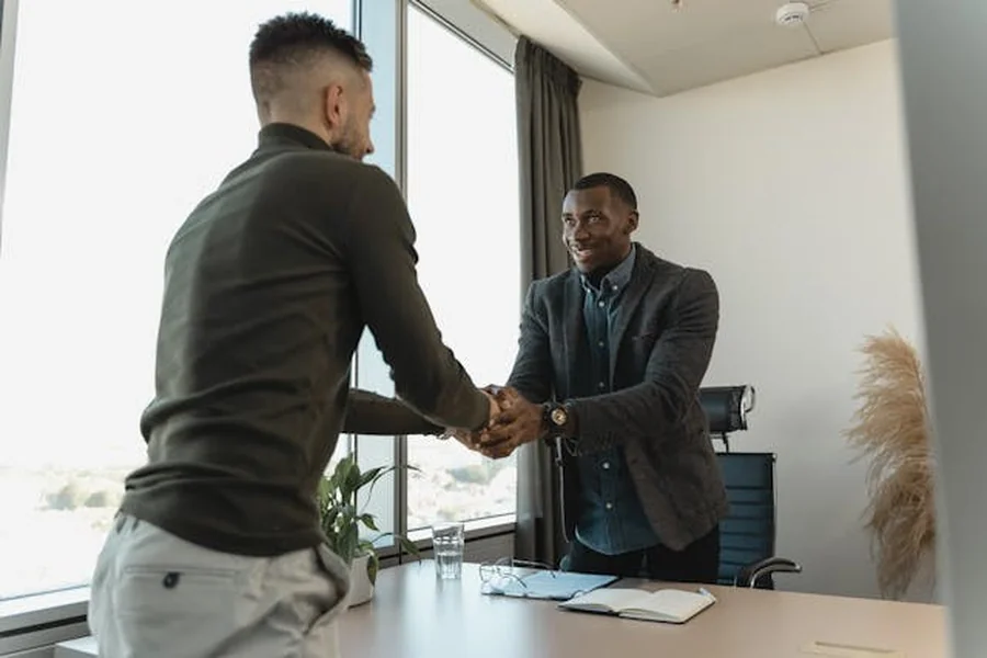 Two men shaking hands in the office